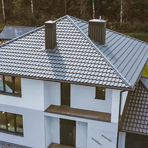 Modern style House with Metal Roof shingles and white stucco siding